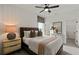 Well-lit bedroom with neutral colors, a fan, and a large window provides a relaxing retreat at 5310 Julep Ct, Cumming, GA 30028