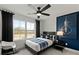 Stylish bedroom with a blue accent wall, a comfortable bed, and a large window at 5310 Julep Ct, Cumming, GA 30028