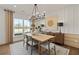 Elegant dining room featuring a modern chandelier, neutral decor, and ample natural light at 5310 Julep Ct, Cumming, GA 30028