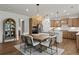 A kitchen with wood cabinets and stainless appliances adjoins a dining area with seating for six at 5310 Julep Ct, Cumming, GA 30028