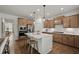 Modern kitchen with stainless steel appliances, a center island, and stylish lighting at 5310 Julep Ct, Cumming, GA 30028