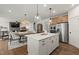 A kitchen features an island with white cabinets, stainless appliances, and hardwood floors at 5310 Julep Ct, Cumming, GA 30028
