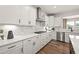 Contemporary kitchen with white cabinets, stainless steel appliances, and elegant countertops at 5310 Julep Ct, Cumming, GA 30028