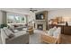Spacious living room with a brick fireplace, large windows, and stylish, comfortable furnishings at 5310 Julep Ct, Cumming, GA 30028