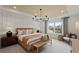 Elegant bedroom with neutral tones, a chandelier, and large windows offering natural light at 5310 Julep Ct, Cumming, GA 30028
