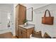 A mud room with storage and seating features granite counters, wood cabinets, and decor pillows at 5310 Julep Ct, Cumming, GA 30028