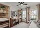 Cozy home office with built-in shelving, desk, and a comfortable seating area with natural light at 5310 Julep Ct, Cumming, GA 30028