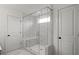 Large glass shower with white marbled tile, a bench and a shower head at 5310 Julep Ct, Cumming, GA 30028