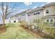 Beautiful backyard with lush green lawn, rock-lined landscaping, and privacy fence at 44 Hall Mnr, Alpharetta, GA 30022