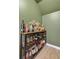 Charming bar area with shelving stocked with various spirits and decorative items at 44 Hall Mnr, Alpharetta, GA 30022