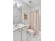 Cozy bathroom featuring a tub with shower, white vanity, and neutral tile at 44 Hall Mnr, Alpharetta, GA 30022