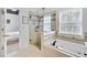 Bathroom with a glass-enclosed shower, separate soaking tub, and neutral tilework, offering a luxurious feel at 44 Hall Mnr, Alpharetta, GA 30022