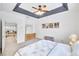 Bright bedroom with a tray ceiling, carpet, and lots of natural light, featuring an ensuite bathroom at 44 Hall Mnr, Alpharetta, GA 30022
