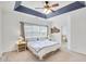 A cozy bedroom featuring a tray ceiling, large window, carpet, and neutral tones for a serene atmosphere at 44 Hall Mnr, Alpharetta, GA 30022