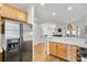 Bright open kitchen featuring stainless steel refrigerator and view of the living area with fireplace at 44 Hall Mnr, Alpharetta, GA 30022