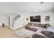 Inviting living room with plush sofa, contemporary rug, and stairs leading to the upper level at 44 Hall Mnr, Alpharetta, GA 30022