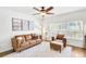 Stylish living room features hardwood floors and ample natural light at 44 Hall Mnr, Alpharetta, GA 30022