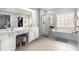 This well-lit bathroom features a double vanity, glass shower, and separate bathtub at 3550 Myrtlewood Chase Nw, Kennesaw, GA 30144