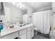 This bathroom features a double sink vanity, a bathtub with a shower, and gray tile at 3550 Myrtlewood Chase Nw, Kennesaw, GA 30144