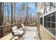 Inviting wooden deck with seating offers a relaxing outdoor space with views of the surrounding trees at 3550 Myrtlewood Chase Nw, Kennesaw, GA 30144