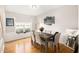 Formal dining room with wainscoting, wood floors, and a view of the front yard at 3550 Myrtlewood Chase Nw, Kennesaw, GA 30144