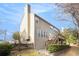 View of a multi-story home with neutral siding, a chimney, and a wooden deck accessible by stairs at 3550 Myrtlewood Chase Nw, Kennesaw, GA 30144