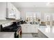 Bright kitchen features white cabinets, stainless steel appliances, and a large window overlooking the backyard at 3550 Myrtlewood Chase Nw, Kennesaw, GA 30144