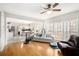 Open living room with hardwood floors, natural light, and view of the kitchen at 3550 Myrtlewood Chase Nw, Kennesaw, GA 30144