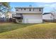 Fenced backyard featuring a grassy lawn and an elevated deck at 6595 Lancelot Ct, Riverdale, GA 30296