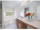 Bathroom with a bathtub and shower combination, light fixtures, and wood cabinets at 6595 Lancelot Ct, Riverdale, GA 30296