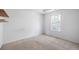Bedroom with bright window and carpet flooring ready for your personal touch at 6595 Lancelot Ct, Riverdale, GA 30296
