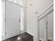 Bright entryway featuring a white door, sidelight window, and dark laminate flooring at 6595 Lancelot Ct, Riverdale, GA 30296