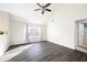Bright living room with large window, vaulted ceilings, and modern dark laminate flooring at 6595 Lancelot Ct, Riverdale, GA 30296