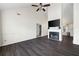 Spacious living room with vaulted ceilings, dark laminate flooring, and a cozy fireplace at 6595 Lancelot Ct, Riverdale, GA 30296