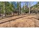 Lush backyard featuring a wooded landscape and a glimpse of the home's rear exterior at 2947 Margaret Mitchell Nw Ct, Atlanta, GA 30327