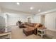 Spacious basement with white trim, drop ceiling, neutral carpet and leather sofa at 2947 Margaret Mitchell Nw Ct, Atlanta, GA 30327