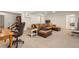 Basement seating area showcasing leather sofa and desk near staircase, and neutral carpeting at 2947 Margaret Mitchell Nw Ct, Atlanta, GA 30327