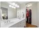 Bright bathroom features a double vanity, large mirror, and walk-in closet at 2947 Margaret Mitchell Nw Ct, Atlanta, GA 30327