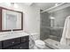 Modern bathroom with tile shower, dark wood vanity and framed mirror at 2947 Margaret Mitchell Nw Ct, Atlanta, GA 30327