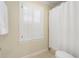 Bathroom showcasing natural light, tiled floors, and a shower with white curtain at 2947 Margaret Mitchell Nw Ct, Atlanta, GA 30327