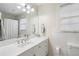 Bright bathroom featuring a white vanity, large mirror, and tiled walls that provide a clean and modern feel at 2947 Margaret Mitchell Nw Ct, Atlanta, GA 30327