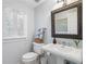 Stylish bathroom featuring a pedestal sink, ample natural light, and a clean design at 2947 Margaret Mitchell Nw Ct, Atlanta, GA 30327