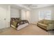 Cozy bedroom with a patterned bedspread, accent furniture, white trim and natural light at 2947 Margaret Mitchell Nw Ct, Atlanta, GA 30327
