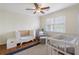 Cozy Bedroom with a crib, glider chair, and natural light, creating a peaceful and welcoming space at 2947 Margaret Mitchell Nw Ct, Atlanta, GA 30327