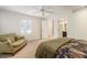 Bedroom featuring patterned bedspread, couch, white trim, neutral carpet and natural light at 2947 Margaret Mitchell Nw Ct, Atlanta, GA 30327