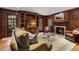 Elegant den with wood paneling, built-in shelving, and a cozy fireplace at 2947 Margaret Mitchell Nw Ct, Atlanta, GA 30327