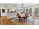 Well-lit dining room with hardwood floors, French doors, and a view to the backyard at 2947 Margaret Mitchell Nw Ct, Atlanta, GA 30327