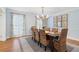Elegant dining room featuring hardwood floors, a chandelier, and ample natural light at 2947 Margaret Mitchell Nw Ct, Atlanta, GA 30327
