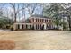 Traditional brick home featuring a manicured lawn and symmetrical design elements at 2947 Margaret Mitchell Nw Ct, Atlanta, GA 30327