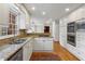 Modern kitchen boasts white cabinets, granite countertops, stainless steel appliances, and wood floors at 2947 Margaret Mitchell Nw Ct, Atlanta, GA 30327